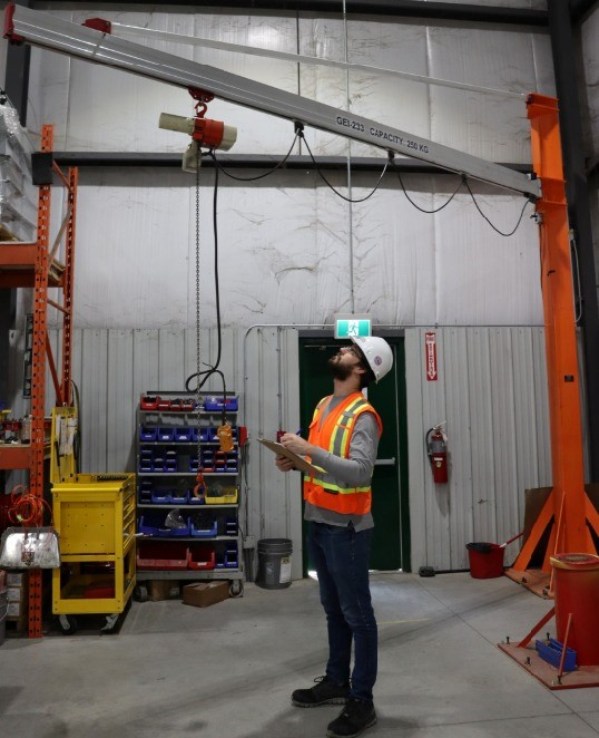 An engineer providing an annual inspection of a crane.