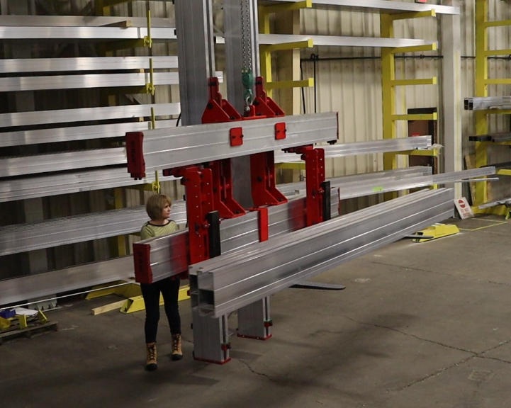 A G-Rail crane lifting materials in a factory