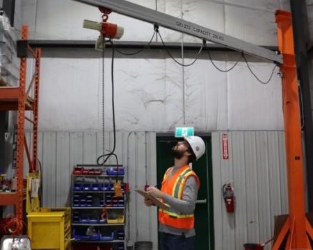 An engineer providing an annual inspection of a bridge crane.