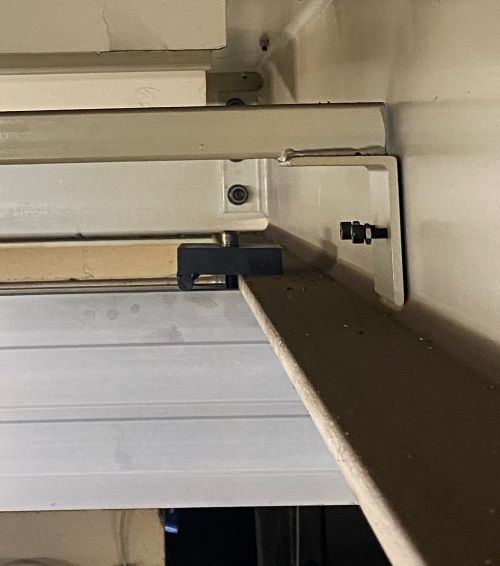 Plate hanger installed on overhead steelwork in a manufacturing facility